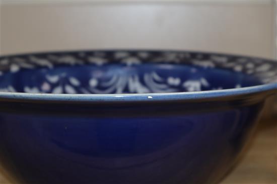A 19th century Chinese white slip decorated blue ground basin diameter 34cm